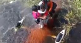 People being rescued from floodwaters.