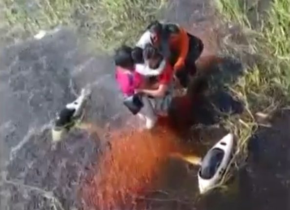 People being rescued from floodwaters.