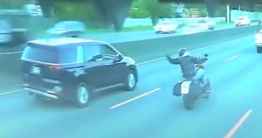 Dashcam footage of a minivan hitting a motorcyclist.