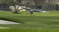 Small plane landing on a golf course.