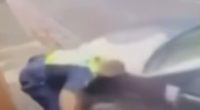Blurry image of a police officer on the ground.