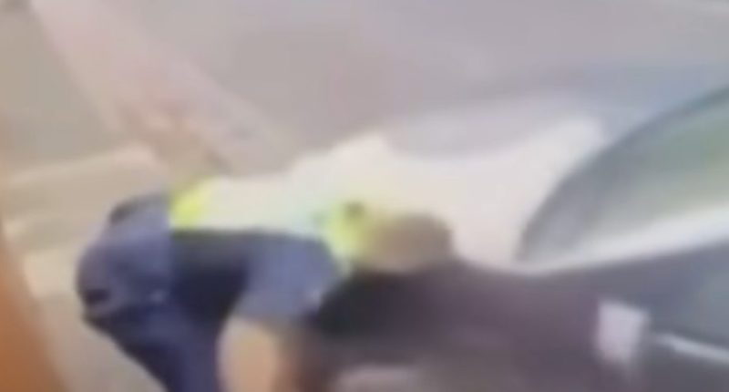 Blurry image of a police officer on the ground.