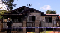 A nine-year-old boy is dead and a woman is under police guard after a suspicious house fire in Toowoomba, Queensland. ï»¿