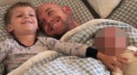 Father and two children lying in bed.