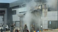Firefighters at the site of a burning building.