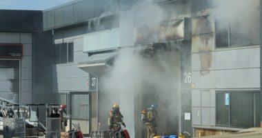 Firefighters at the site of a burning building.