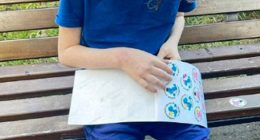 An eight-year-old boy looking at stickers.