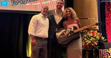 Travis Kelce poses with fans who bought Taylor Swift merch