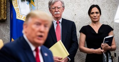 John Bolton and Stephanie Grisham listen as President Trump meets with the Amir of Qatar in the Oval Office.