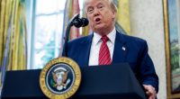 President Trump speaking at a podium in the Oval Office.