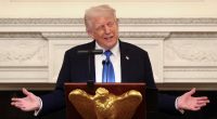 President Donald Trump speaking at a podium.