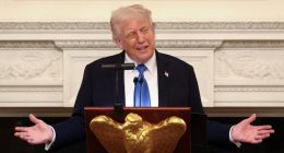 President Donald Trump speaking at a podium.
