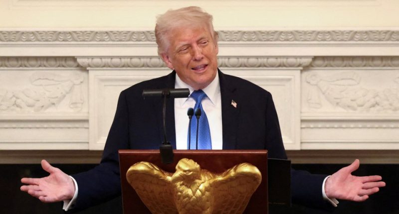 President Donald Trump speaking at a podium.