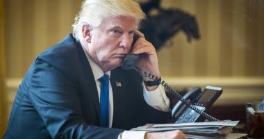 President Donald Trump on the phone in the Oval Office.