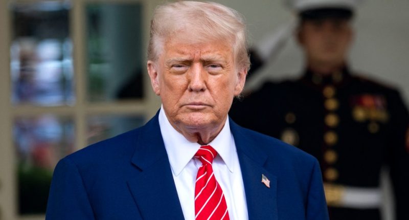 Donald Trump in a blue suit and red tie outside the White House.