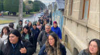 Large group of people walking down a street.