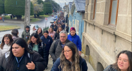 Large group of people walking down a street.