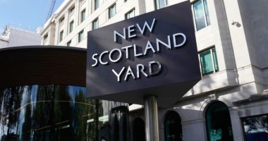 A sign stands in front of the New Scotland Yard, the headquarters of the London Metropolitan Police