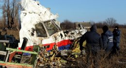 Workers recovering wreckage from the Malaysia Airlines Flight 17 crash site.