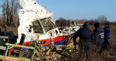 Workers recovering wreckage from the Malaysia Airlines Flight 17 crash site.