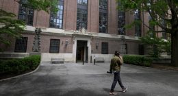 A student walks on the campus of Harvard University in Cambridge, Massachusetts