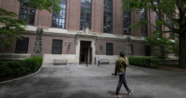 A student walks on the campus of Harvard University in Cambridge, Massachusetts