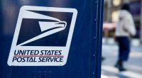 USPS logo on a blue mailbox.