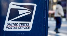 USPS logo on a blue mailbox.