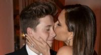 Victoria Beckham dazzles in a plunging black gown with son Brooklyn