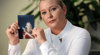Woman holding a photograph of a younger woman.