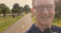 Ohio weatherman Mark Johnson holding a microphone with the ABC 5 logo.