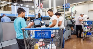 Family using self-checkout at Walmart.