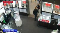 Security camera footage of a jewelry store robbery; a man is tackled by a bystander.