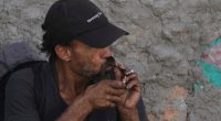Person smoking crack cocaine.