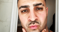 Close-up selfie of a man with short hair and a mustache.