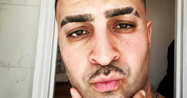 Close-up selfie of a man with short hair and a mustache.