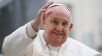 Pope Francis waving to a crowd.