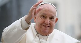Pope Francis waving to a crowd.