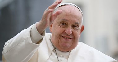 Pope Francis waving to a crowd.