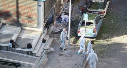 Forensic experts investigating a bomb explosion scene.