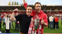 Wrexham co-owners Rob McElhenney and Ryan Reynolds celebrate with the League One trophy