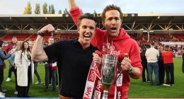 Wrexham co-owners Rob McElhenney and Ryan Reynolds celebrate with the League One trophy