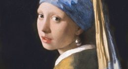 Painting of a girl wearing a blue and yellow headscarf and a pearl earring.