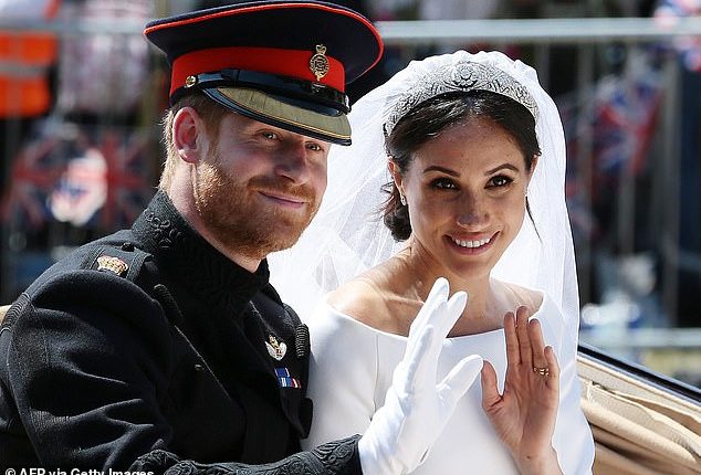 Harry and Meghan wave from the Ascot Landau Carriage during their carriage procession on the Long Walk as they head back towards Windsor Castle after their wedding ceremony