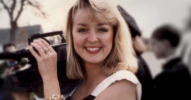 Jodi Huisentruit is pictured holding a camera.