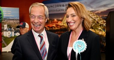 Nigel Farage and Sarah Pochin smile as they speak to the media during a vote recount