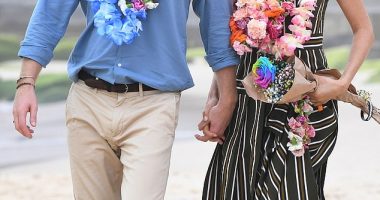 Prince Harry and Meghan Markle walk along Bondi Beach in Sydney, Australia, in 2018