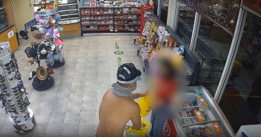 Shirtless armed robber caught on CCTV holding up service station