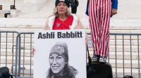 FILE - Micki Witthoeft, center, mother of Ashli Babbitt, the woman fatally shot by police inside the U.S. Capitol during the Jan. 6, 2021, riot, joins protesters outside of the Supreme Court on the second anniversary of the Jan. 6, assault on the U.S. Capitol, in Washington,, Jan. 6, 2023. (AP Photo/Jose Luis Magana)
