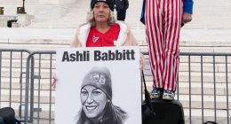 FILE - Micki Witthoeft, center, mother of Ashli Babbitt, the woman fatally shot by police inside the U.S. Capitol during the Jan. 6, 2021, riot, joins protesters outside of the Supreme Court on the second anniversary of the Jan. 6, assault on the U.S. Capitol, in Washington,, Jan. 6, 2023. (AP Photo/Jose Luis Magana)